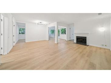 Bright living room boasts natural light, fireplace, and light-toned floors, creating an inviting and airy atmosphere at 22 Dunwoody Springs Dr # 22, Atlanta, GA 30328