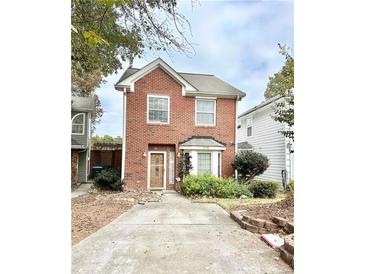 Charming two-story brick home with a well-manicured front yard and a cozy, inviting entrance at 3948 Oak Glenn Dr, Duluth, GA 30096