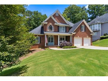Charming brick home with a well-manicured lawn and inviting curb appeal at 2713 Misty Rock Cv, Dacula, GA 30019