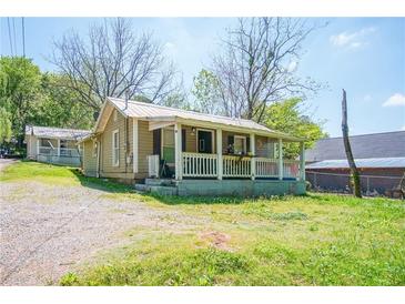 Charming exterior of a house with a cozy porch and a well-maintained front yard at 1422 Cassville Nw Rd, Cartersville, GA 30121