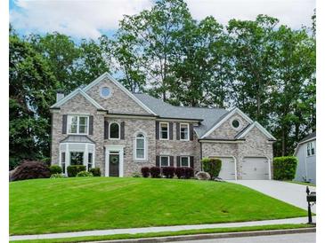 Beautiful two-story home with a well-manicured lawn, lush landscaping, and a two-car garage in a desirable neighborhood at 2115 Bentbrooke Trl, Lawrenceville, GA 30043