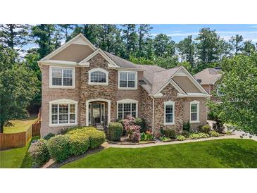 Beautiful brick home with manicured lawn and mature landscaping, offering great curb appeal at 2241 Chaseford Ln, Powder Springs, GA 30127