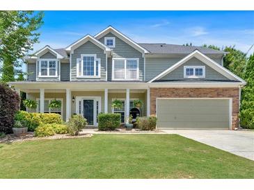 Charming two-story home featuring a well-manicured lawn, inviting porch, and a two-car garage at 204 Sawtooth Ct, Canton, GA 30114