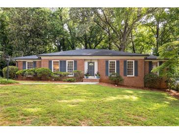 Charming brick home with manicured lawn and mature trees offering great curb appeal at 1342 Old Johnson Ferry Ne Rd, Brookhaven, GA 30319