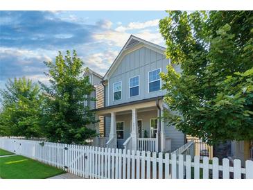 Charming two-story home features a well-manicured lawn and a welcoming white picket fence at 3057 Windover Ln, Kennesaw, GA 30144