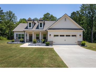 Charming single-Gathering home with a two-car garage and meticulously manicured front yard at 2124 Bullock Bluff Dr, Loganville, GA 30052
