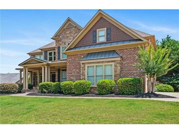 Charming two-story brick home with stone accents and a well-manicured lawn at 307 Heritage Overlook, Woodstock, GA 30188