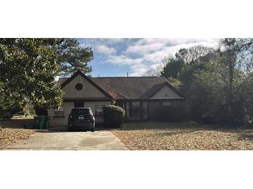 Charming single-story home featuring a cozy front yard and a well-maintained driveway at 3390 Autumn Cherry Ct, Decatur, GA 30034