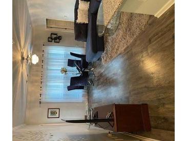 Modern living room with a blue sofa, wood floors, and stylish décor at 4333 Dunwoody Park, Atlanta, GA 30338