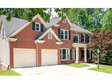 Classic two-story brick home with black shutters and a two-car garage at 672 Red Sunset Cir, Powder Springs, GA 30127