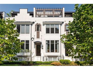 Elegant white townhome with black window trim, shutters, and iron railing fence at 144 Northern Ave, Decatur, GA 30030