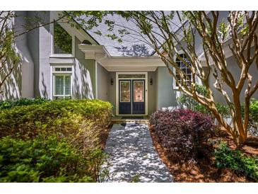 Inviting front entrance featuring a double door framed by lush landscaping at 410 Waterridge Ct, Sandy Springs, GA 30350