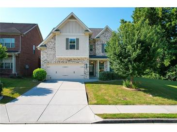 Charming two-story home with a well-manicured lawn and attached two-car garage at 2600 Arnold Palmer Way, Duluth, GA 30096