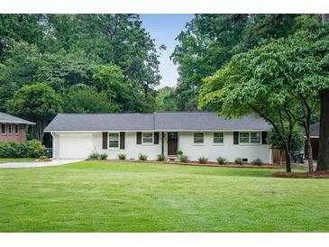 Charming single-story home with well-manicured lawn and mature trees at 2617 Warwick Ne Cir, Atlanta, GA 30345