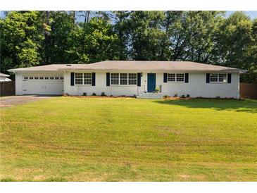 Charming single-story home with a well-manicured lawn, white brick facade, and blue shutters at 159 Lloyd Dr, Marietta, GA 30066