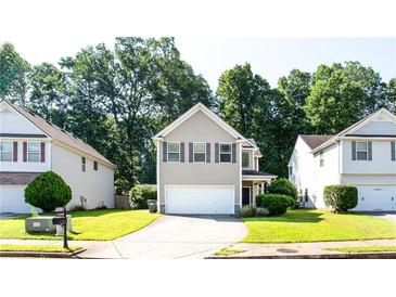 Charming two-story home featuring neutral siding, a well-manicured lawn and a two car garage at 4628 Mcever View Dr, Sugar Hill, GA 30518