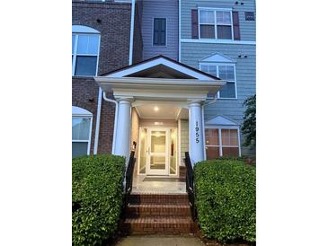 Welcoming front entrance with covered porch and well-maintained landscaping at 1955 Nocturne Dr # 3105, Alpharetta, GA 30009