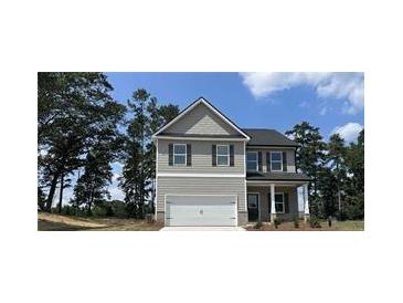 Charming two-story home with gray siding, a covered porch, and an attached two-car garage at 45 Heyman Dr, Covington, GA 30016