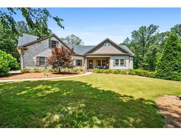 Charming stone and siding home with a well-manicured lawn and inviting front porch at 150 Seals Rd, Dallas, GA 30157
