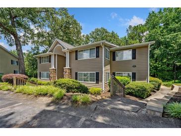 Traditional two-story townhouse featuring stone accents, black shutters, and mature trees at 1468 Briarwood Ne Rd # 406, Brookhaven, GA 30319