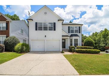 Charming two-story home with a well-maintained lawn and a two-car garage at 3710 Ridgefair Dr, Cumming, GA 30040