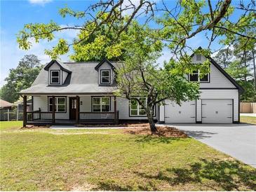 Charming two-story home with a welcoming front porch and attached two-car garage at 2979 Overwood Sw Ln, Snellville, GA 30078
