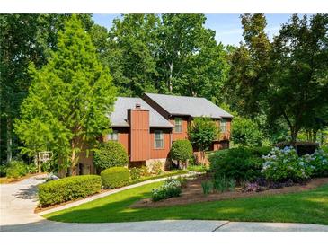 Charming two-story home with a beautiful landscaped yard and mature trees at 278 Shire Way, Lawrenceville, GA 30044