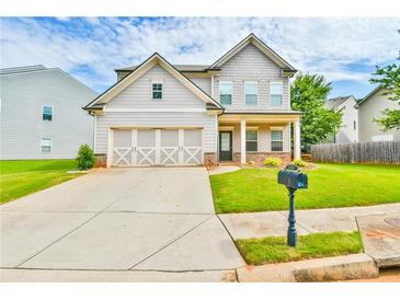Charming two-story home featuring a well-maintained lawn, a two-car garage, and inviting curb appeal at 2102 Black Pebble Cir, Buford, GA 30519