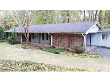 Charming brick home with a covered porch, mature trees, and well-maintained landscaping at 276 Colewood Nw Way, Atlanta, GA 30328