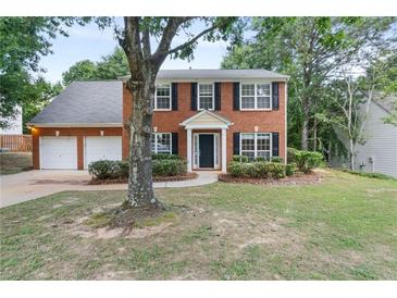 Charming two-story brick home featuring a two-car garage and well-manicured front lawn at 2683 Berry Ridge Ct, Buford, GA 30519