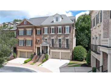Elegant townhome with brick facade, attached garages, and well-maintained landscaping at 2283 Falmouth Se Ct # 22, Smyrna, GA 30080