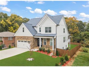 Beautiful two-story home featuring a stone and white shingle facade with well-manicured front yard at 474 Haley Se St, Marietta, GA 30060