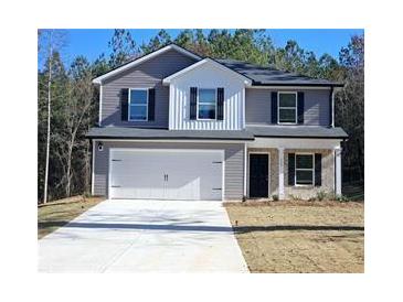 Charming two-story home with a large front yard and attached two-car garage at 15 Barton Ln, Covington, GA 30016