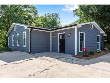 Charming home exterior with gray siding, white trim, and a well-maintained front yard at 356 Lake Dr, Atlanta, GA 30354