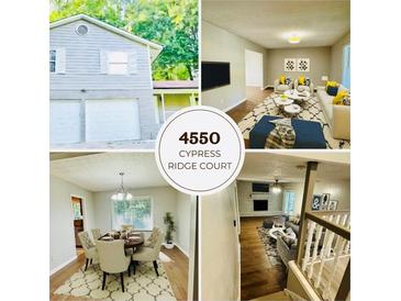 Charming two-story home with a well-manicured lawn and a two-car garage at 4550 Cypress Ridge Ct, Stone Mountain, GA 30083