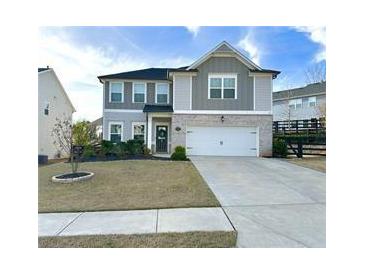 Charming two-story home with well-manicured lawn and a two-car garage, perfect for suburban living at 306 Coppergate Ct, Canton, GA 30115