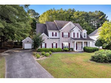 Beautiful two-story home with landscaped yard and a detached two car garage at 5735 Lake Windsor Pkwy, Buford, GA 30518