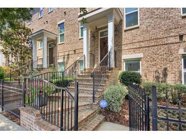 Charming brick townhome with wrought iron railings and landscaped front yard at 328 Brownstones Cir, Atlanta, GA 30312