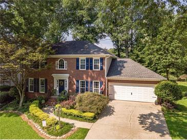 Charming brick home with mature trees and a well-manicured lawn at 4105 Vicksburg Dr, Lawrenceville, GA 30044