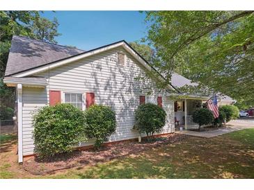 Charming single-story home with light siding, dark shutters, mature landscaping, and a well-maintained lawn at 600 Cowan Rd, Covington, GA 30016