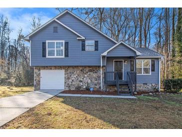 Charming two-story home featuring a stone facade and blue siding at 100 Spicewood Ct, South Fulton, GA 30349