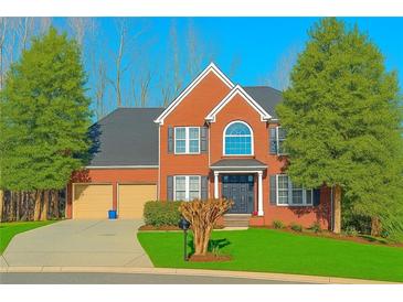 Charming two-story home with manicured lawn, mature trees, and a two-car garage at 505 Armor Knl, Powder Springs, GA 30127