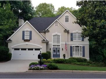 Charming two-story home featuring a well-manicured lawn, attached garage, and stately curb appeal at 6380 Bannerhorn Run, Alpharetta, GA 30005