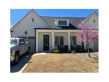 Charming home with a well-manicured lawn and a inviting front porch at 5099 Noble Village Way, Lilburn, GA 30047