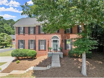 Charming two-story brick home with landscaped yard and welcoming front entrance at 1520 Dorchester Dr, Lawrenceville, GA 30043