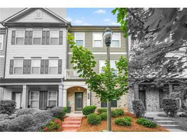 Charming townhome with landscaped front yard and brick-paved walkway to the front door at 3641 Princeton Ave, Atlanta, GA 30337