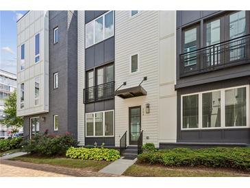 Beautiful townhome with manicured landscaping and striking architectural details at 704 Banton Nw Dr, Atlanta, GA 30318