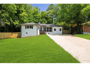 Charming single-story home featuring a well-maintained lawn and a long driveway at 3388 Elgin Dr, Decatur, GA 30032