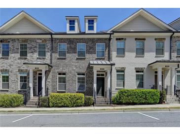 Charming brick townhomes with well-maintained landscaping and inviting front entrances at 3879 Glenview Club Ln, Duluth, GA 30097