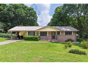 Charming single-story brick home featuring a manicured lawn and convenient carport at 434 Terrace Sw Dr, Smyrna, GA 30082